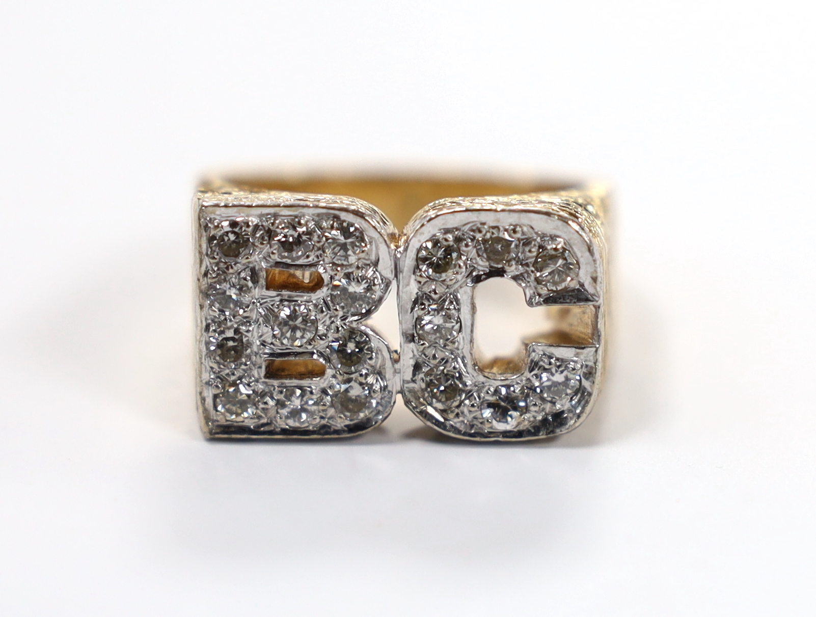 A textured 9ct and diamond cluster set 'BC' initials ring, size Q, gross weight 14.3 grams.